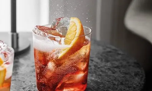Campari cocktail over ice with an orange slice