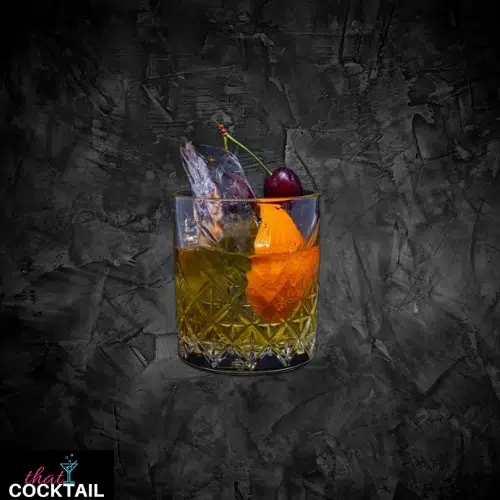 Amaretto Sour in a rocks glass with an orange wedge and a cherry