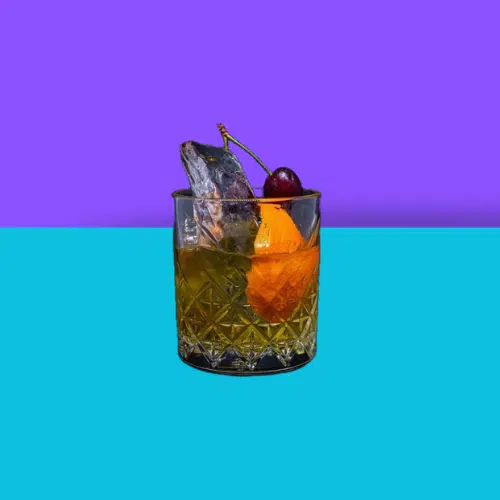 Mai Tai in a rocks glass with an orange wedge and a cherry