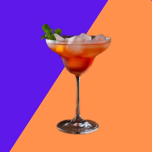 Amber Rolling Thunder cocktail in a stemmed glass with crushed ice and mint