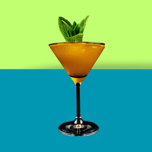 Pornstar Spritz in a martini glass with a mint sprig