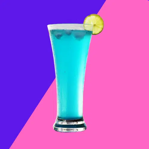 Sex In the Driveway in a tall glass, bright blue with a lime wheel