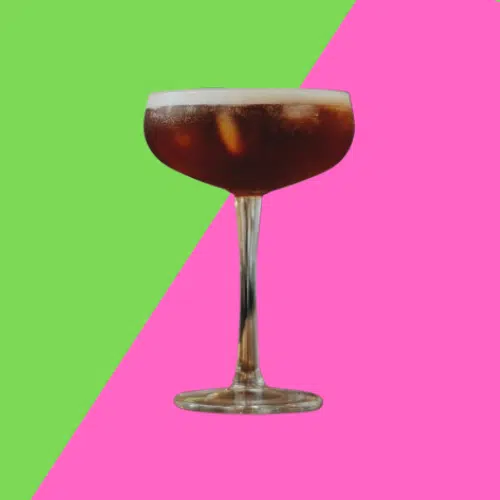 Dark Miss Belle cocktail in a coupe glass