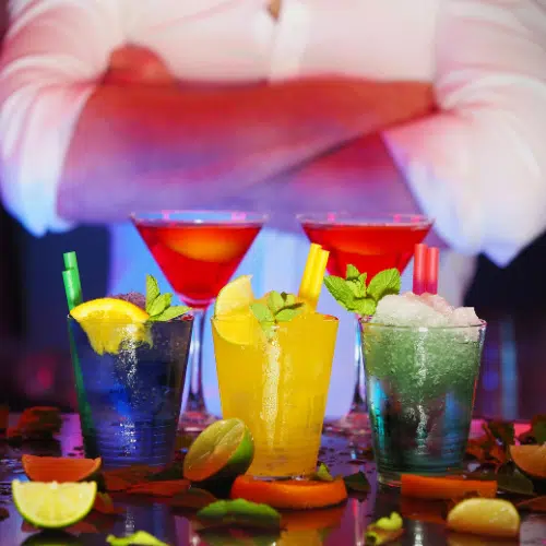 Colourful modern cocktails garnished with fresh fruit