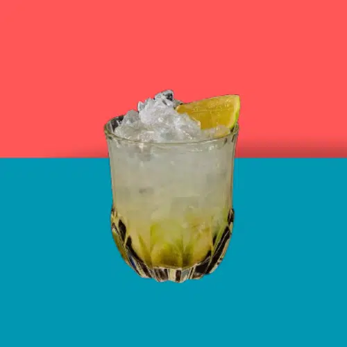 Caipirinha in a rocks glass with crushed ice and lime